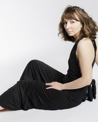 Woman in black dress on white background with filmgrain