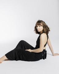 Woman in black dress on white background with filmgrain