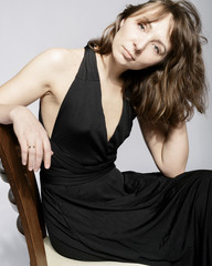 Woman in black dress on white background with filmgrain