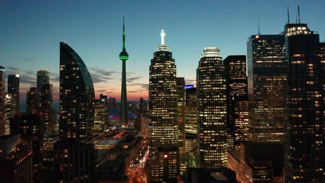 29.98P dusk flying backward and tilting down on Toronto skyline