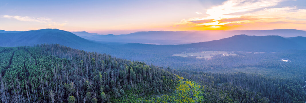 Aerial panorama of vivid sunset over mountains in Victoria, Australia
