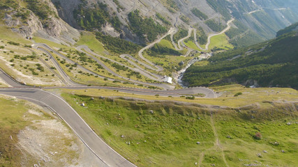 DRONE: Cars driving on a mountain switchback road in the Italian Dolomites.