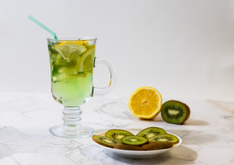 Refreshing lemonade from kiwi and lemon on a light background. Horizontal orientation