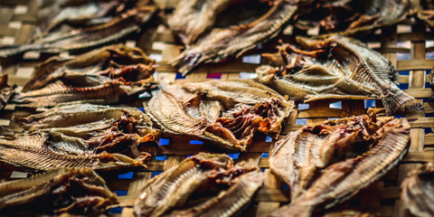  Dried fish in a bamboo basket. Preserving food for longer storage.