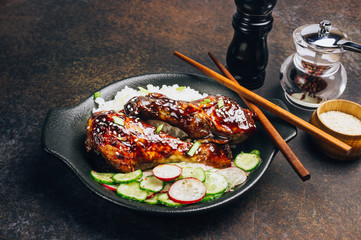Fried chicken legs with teriyaki sauce sesame seeds and rice