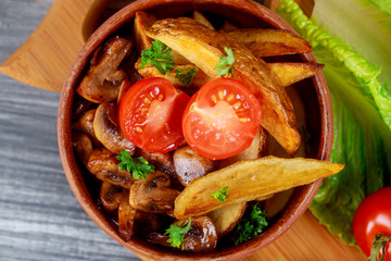 A close up champignon mushrooms with oven baked potato and tomato