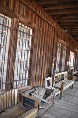 Arizona's Goldfield ghosttown: weathered buildings and furniture, wooden stairwells, rusted stove, and vintage wooden sidewalks
