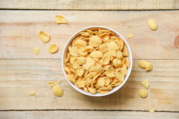 Cornflakes breakfast in bowl on wooden background for cereal healthy food