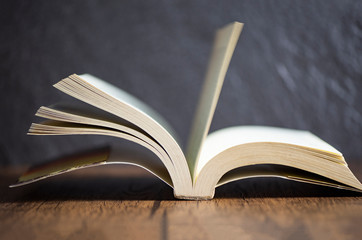 open book vintage on old wooden table dark background at library education concept