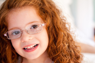Happy Little Red Haired Girl Wearing Glasses - Portrait