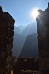 Machu Picchu sunrise behind mountains