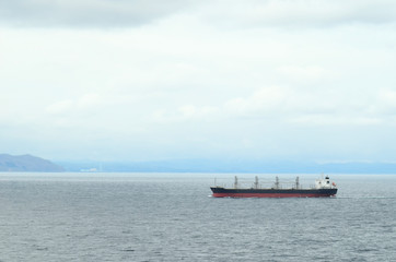 Bulk carrier ship sailing near Japanese island Hokkaido.