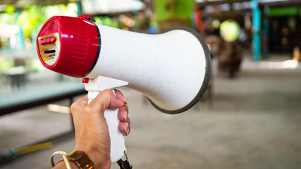 Hand holding Megaphone To use news announcements.