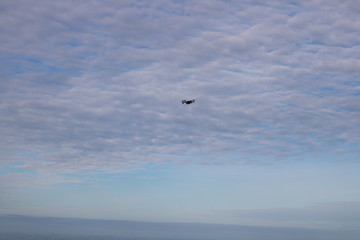 Fototapeta na wymiar Drone Flying Cloudy Sky Background 1
