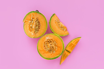 Yellow cantaloupe melon on pink background