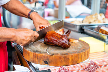 slicing grilled duck