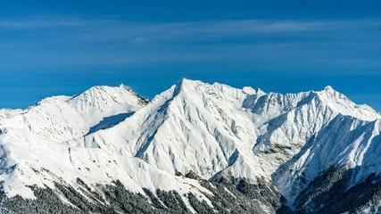 Awesome view of the Caucasus mountains covered by snow in the ski resort of Krasnaya Polyana, Russia.