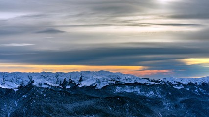 Sunset over the Caucasus mountains covered by snow in the ski resort of Krasnaya Polyana, Russia.