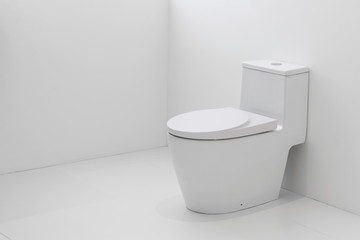 Fototapeta na wymiar White flush toilet in white bathroom.