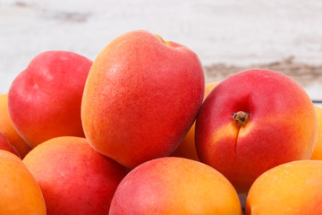 Apricot or peach on rustic board as healthy snack or dessert. Food containing vitamins and minerals