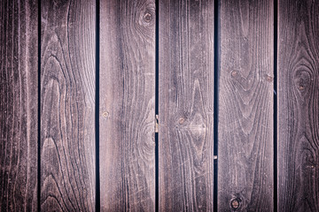 Background with texture of old wood. Fence of vertical old boards. Photo for layouts with vignette.