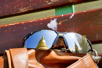 The reflection on a traveller's sunglasses at Wat Saket. This place is a landmark of Bangkok Thailand