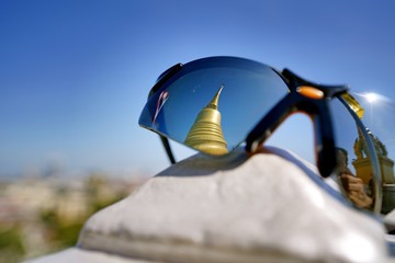 The reflection on a traveller's sunglasses at Wat Saket. This place is a landmark of Bangkok Thailand