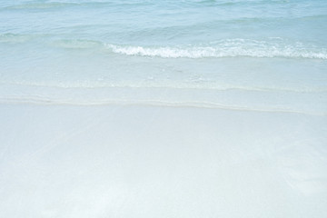 Soft wave of blue and green ocean/sea on sandy beach. Background.