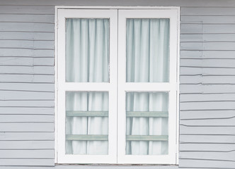 White window doors on old gray wooden houses.