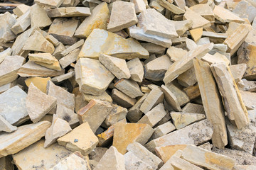 Background, pile, of pieces of roughly broken raw marble stones