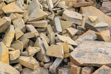 Background, pile, of pieces of roughly broken raw marble stones