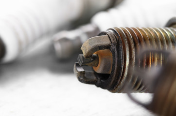 Closeup photo of old used spark plug for internal combustion engine. Space for text