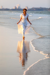 Woman in white dress on beach