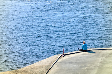 people walking along the promenade, Biking and scooters, watching the water flowing river or sea 