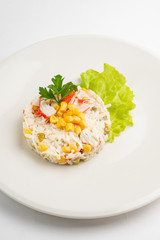 salad made of crab sticks, corn, egg, pepper, and cucumber