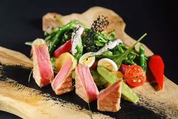 tuna with salad on the wooden board