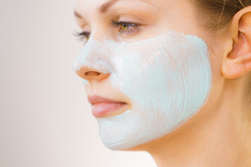 Girl with white green mud mask on face