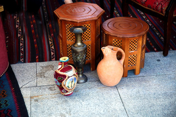 Azerbaijan national interier with old-fashioned clay pots,carpet and copper dish 