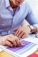 Selective focus of male hand above the book