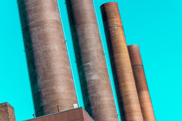Abstract deliberately crooked image of the chimneys of the power plant of a large industrial plant