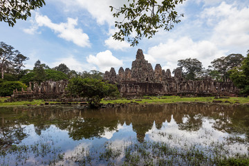 Fototapeta na wymiar Beautiful Bayon temple reflected in the surrounding pond, Siem Reap, Cambodia