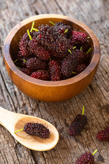Fresh mulberry fruit on wood table background