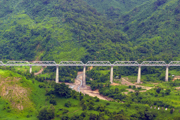 Fototapeta na wymiar railway bridge built on the hills in the jungle, beautiful landscape