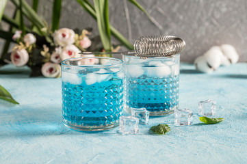 Blue Lagoon cocktails on rustic background