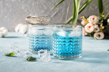 Blue Lagoon cocktails on rustic background