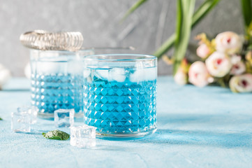 Blue Lagoon cocktails on rustic background