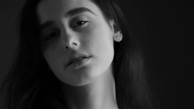 Closeup portrait of a beautiful girl. Black and white video.