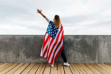 Happy woman holding an American Flag