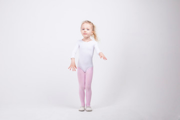 Happy little girl dancing isolated on white background