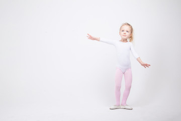 Happy little girl dancing isolated on white background